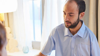 Person wearing light blue button down shirt