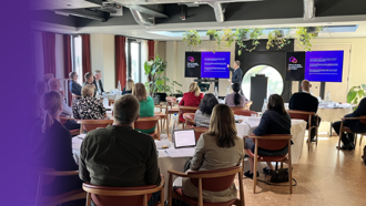 business professionals sat at a conference