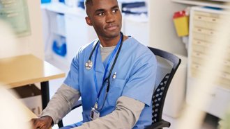 Individual in healthcare industry sitting at a desktop at work