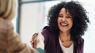 Woman smiling and shaking hands