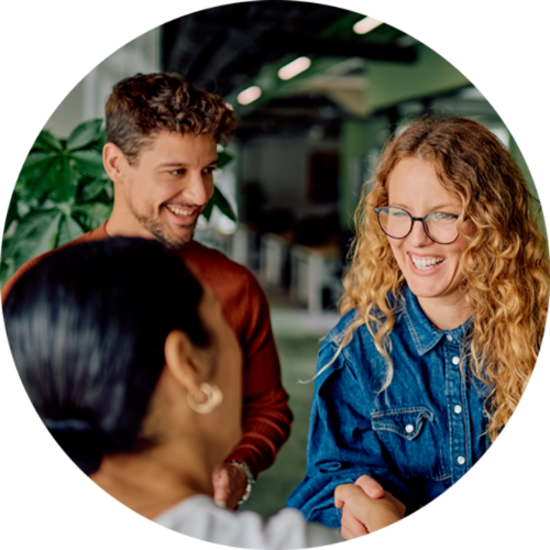 three people talking and shaking hands