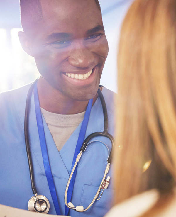 Nurse smiling while interacting with patient 