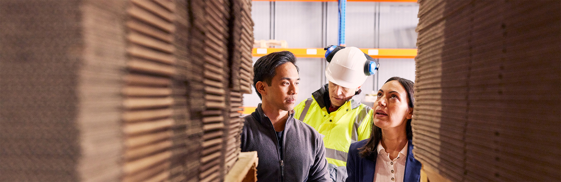 3 people looking at palette racking