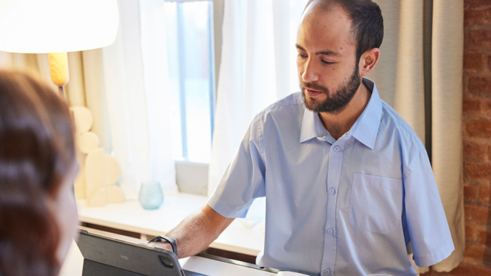 Person wearing light blue button down shirt