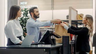 Customers making a purchase at a counter