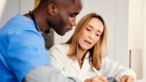 Two individuals working together in the healthcare sector