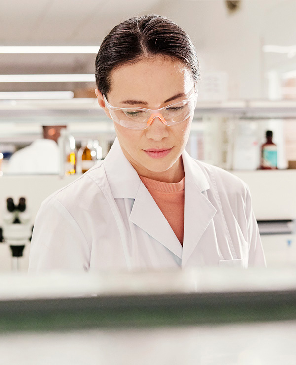 lab tech with safety glasses on working