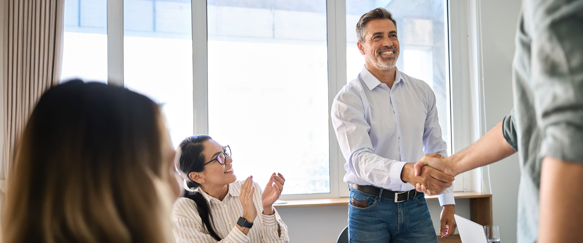 People shaking hands in a meeting
