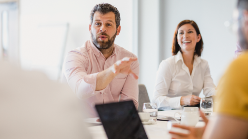 Two people sitting around a meeting table