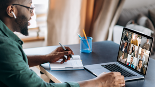 Man at computer desk on video conference call