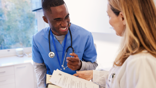 Nurse and doctor chatting over a chart 