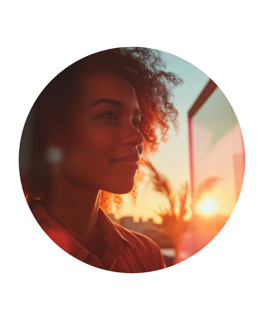 Woman looking into distance at sunset