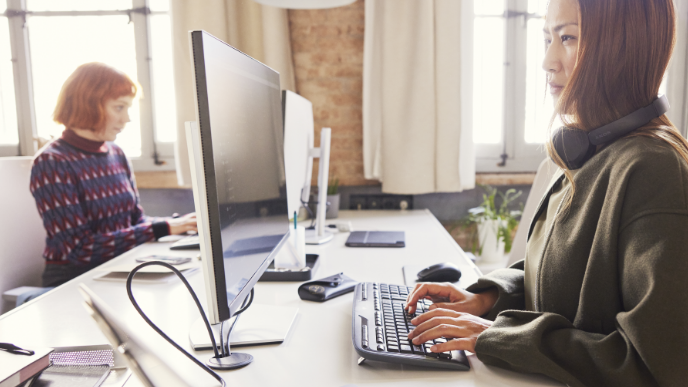 Two women at computers in a co-working space 