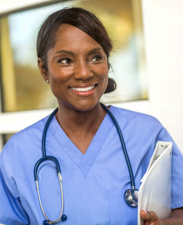 Nurse smiling while interacting with patient