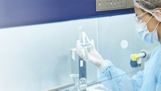 Individual examining a product with gloves on