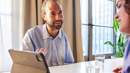 two people sitting at a table having a job interview