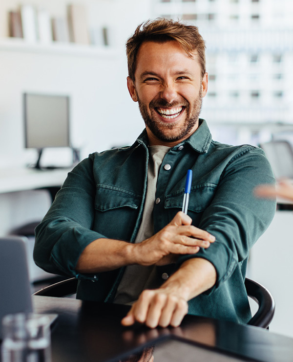 Man holding pen in his hands at conference table 