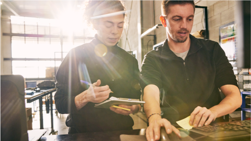 Female and male working in a warehouse at a computer