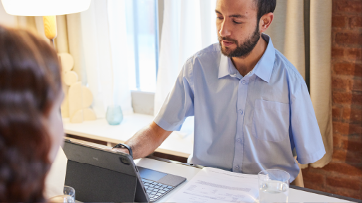 Man with one arm sitting as desk interviewing job candidate