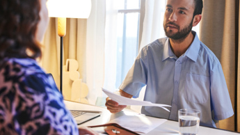 Photo of two people sitting at a table working together