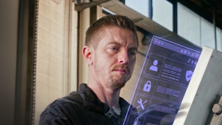 Individual observing a digital screen with icons and information on it