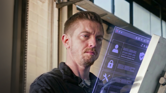 Individual observing a digital screen with icons and information on it