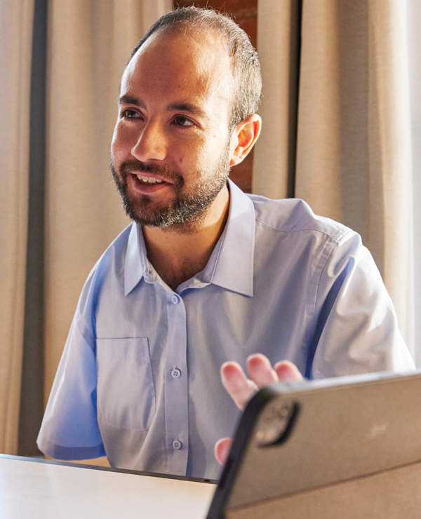 Smiling man at desk with tablet