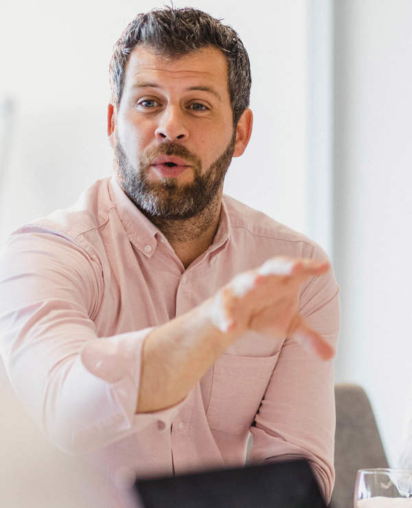 Man talking with his hands at conference table 