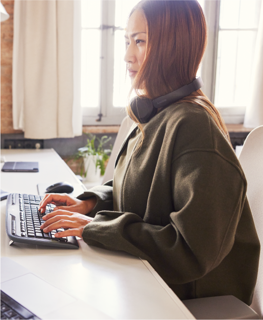 Woman sitting at a computer typing