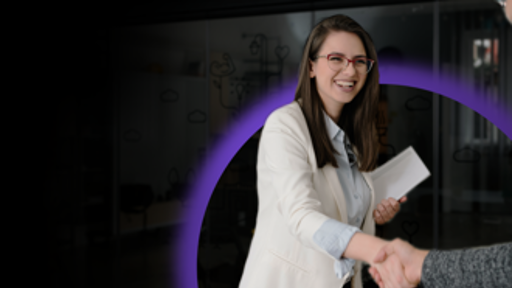 Woman holding document shaking another person's hand