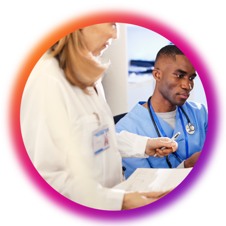 Photo of a doctor and a nurse looking at a patient’s chart