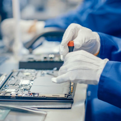 Hands with gloves working safely in the semiconductor industry