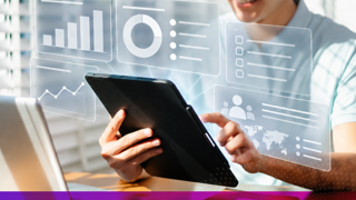 Person on tablet with graphics of modules and graphs appearing to come out of the tablet screen