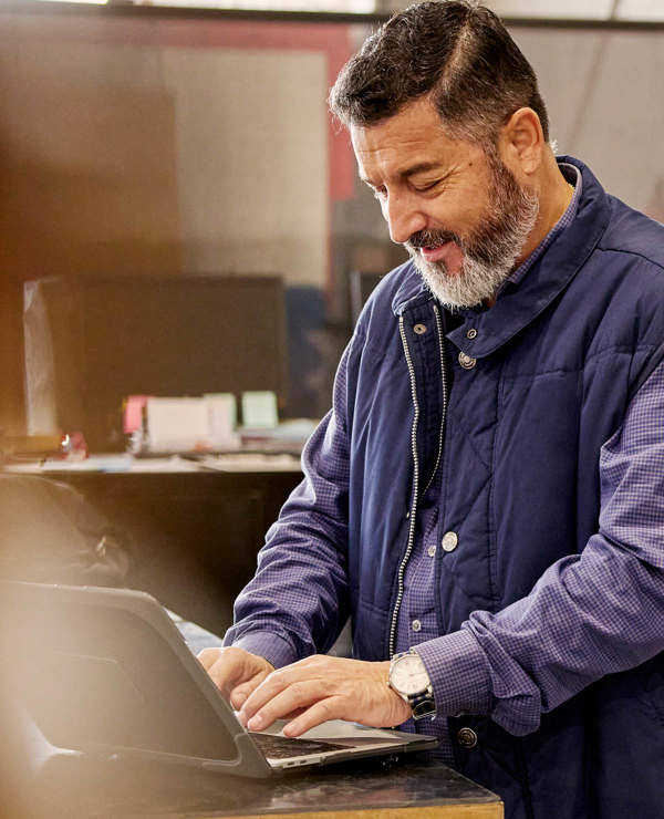 Man with a beard at table on laptop