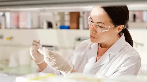 Woman with safety glasses in lab